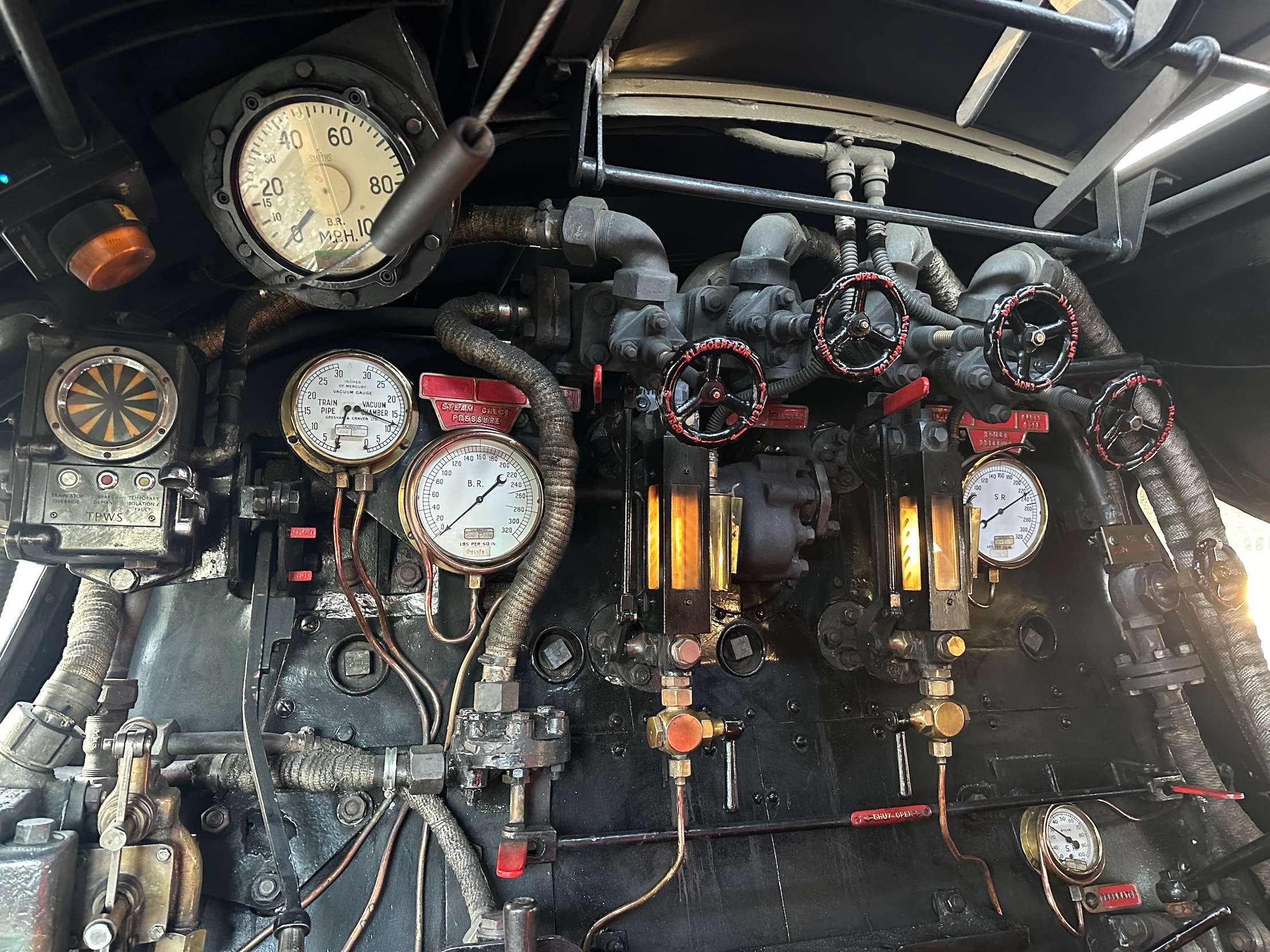 The controls of 35028, the water gauges for the boiler in the centre and the drivers controls on the left.