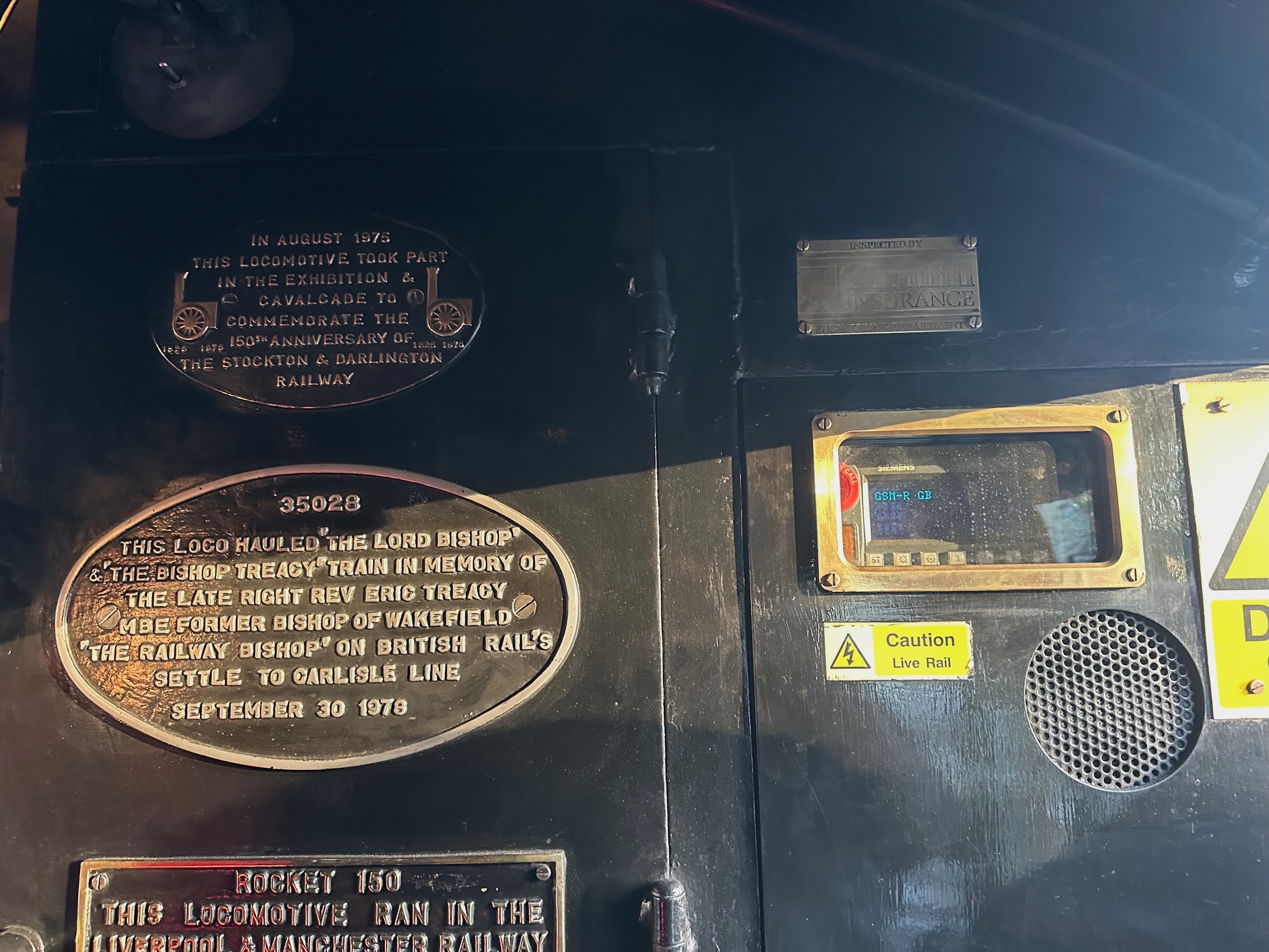 The plaque for the insurance inspection company and the cupboard with the GSM-R radio next to the event plaques.